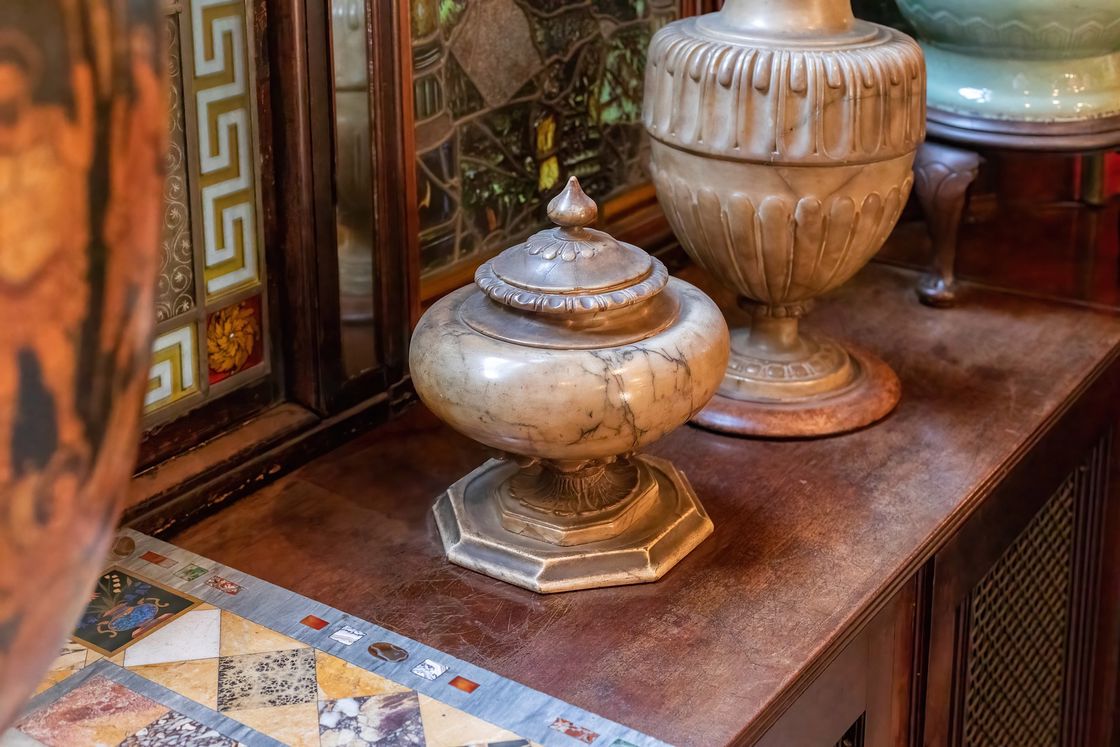 Urns displayed on top of a wooden cabinet