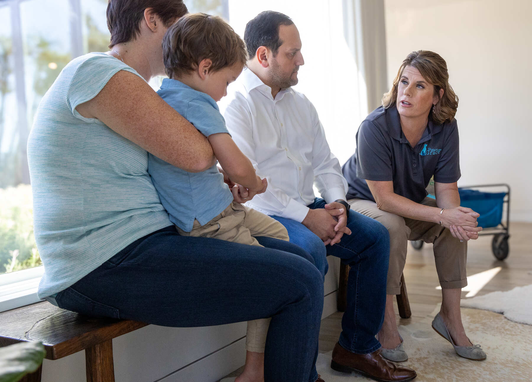 A family speaking with a veterinary professional indoors