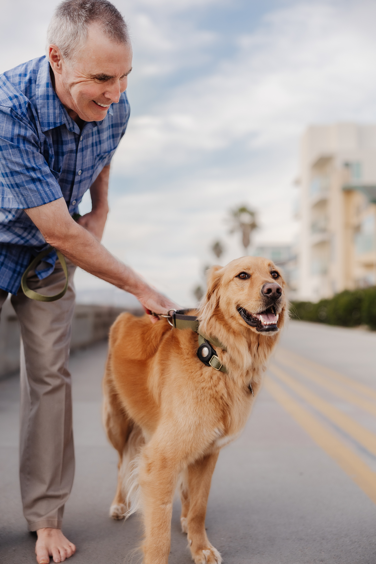 Man walking his dog along a seaside path