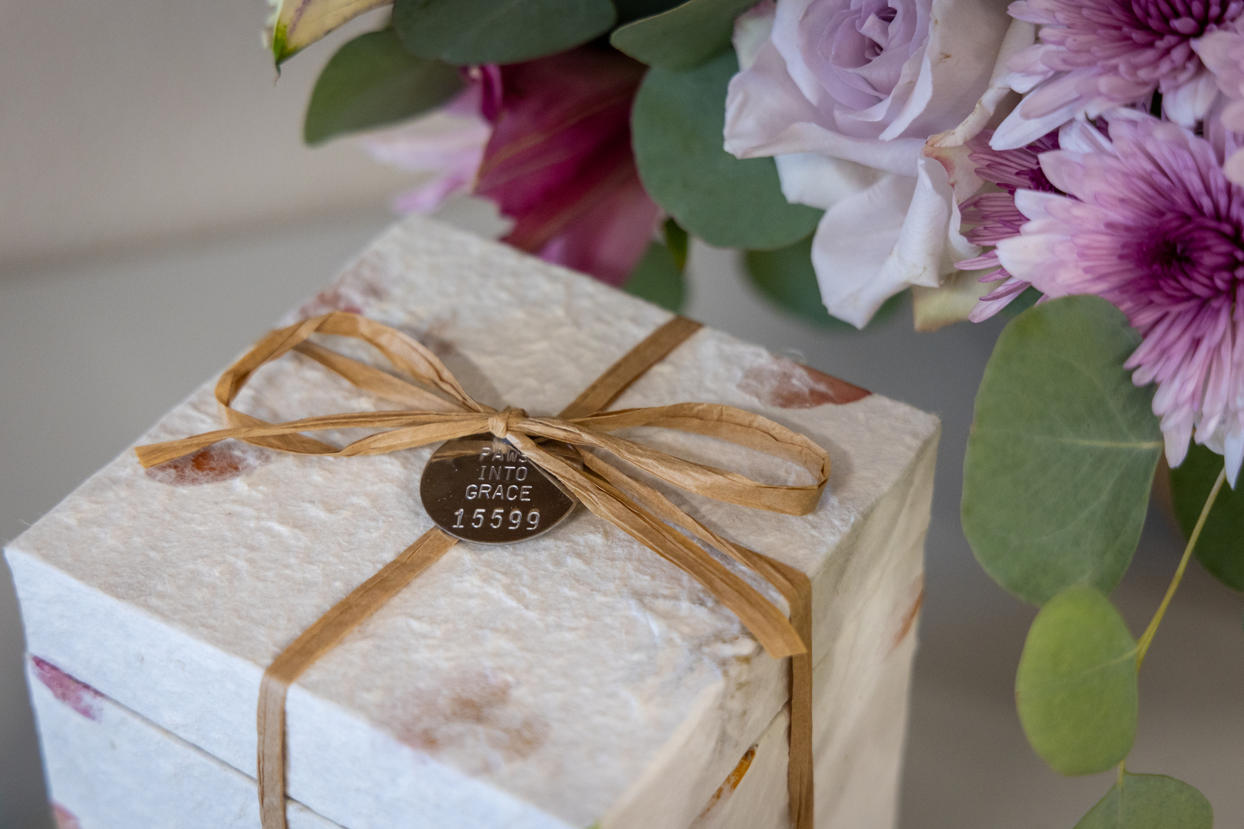 A white gift box adorned with a neatly tied ribbon