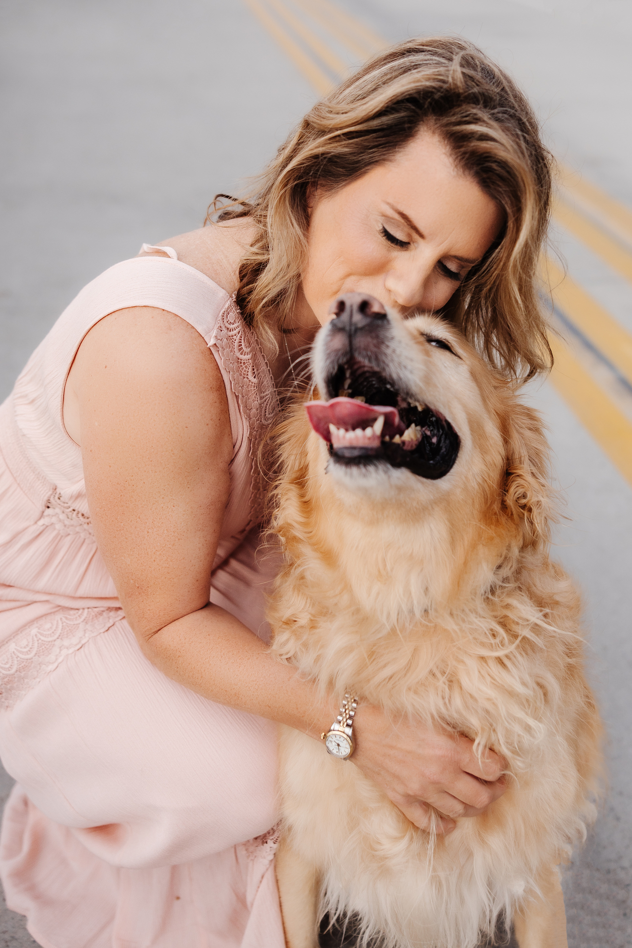 Woman hugging a senior golden retriever