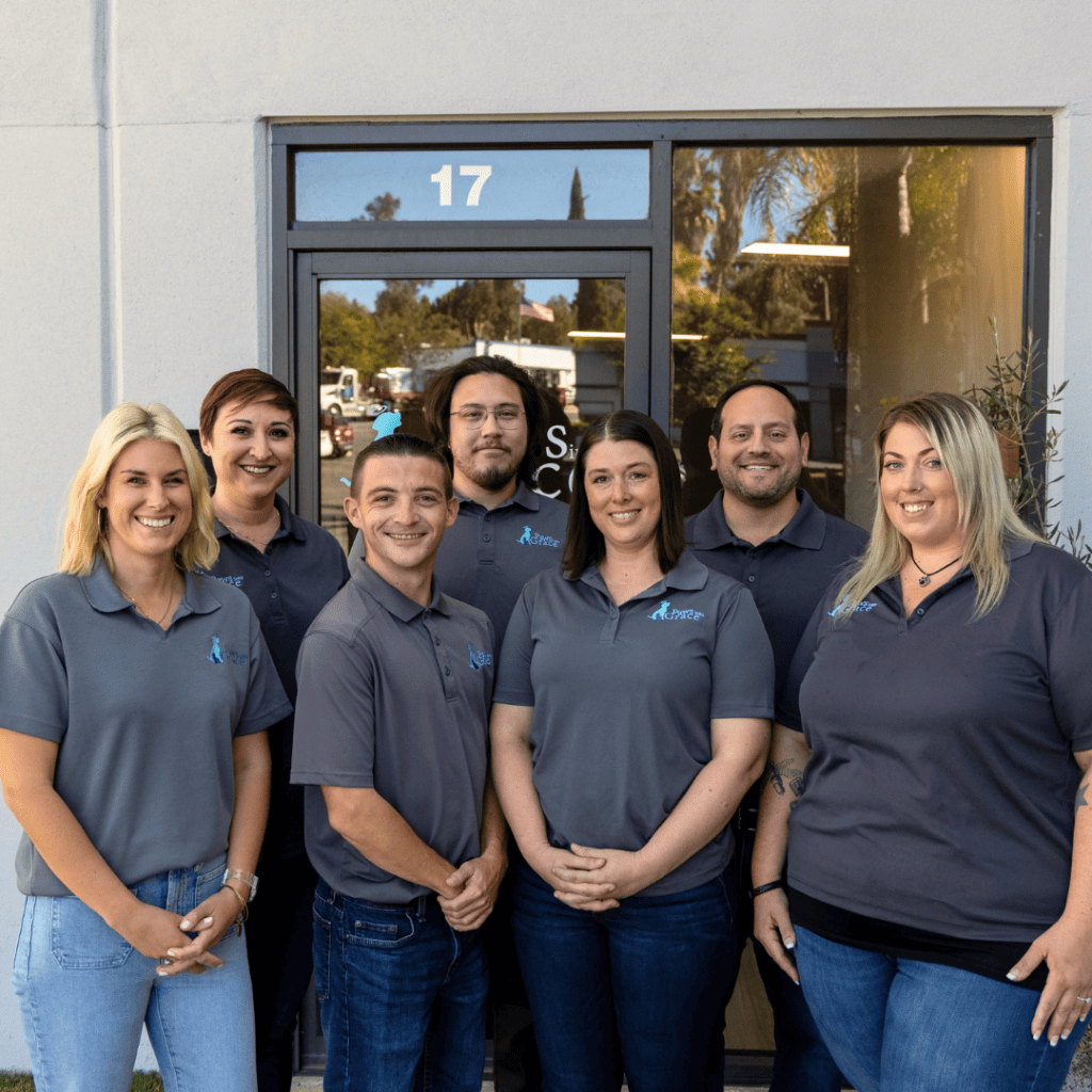 A group of employees standing for a picture outside their clinic.