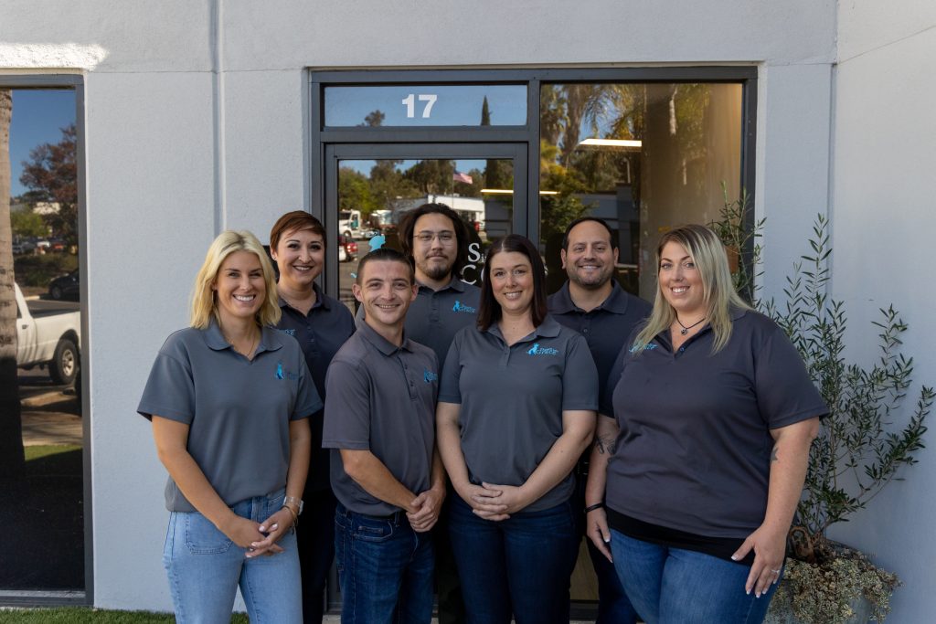 Paws Into Grace staff standing outside the facility entrance