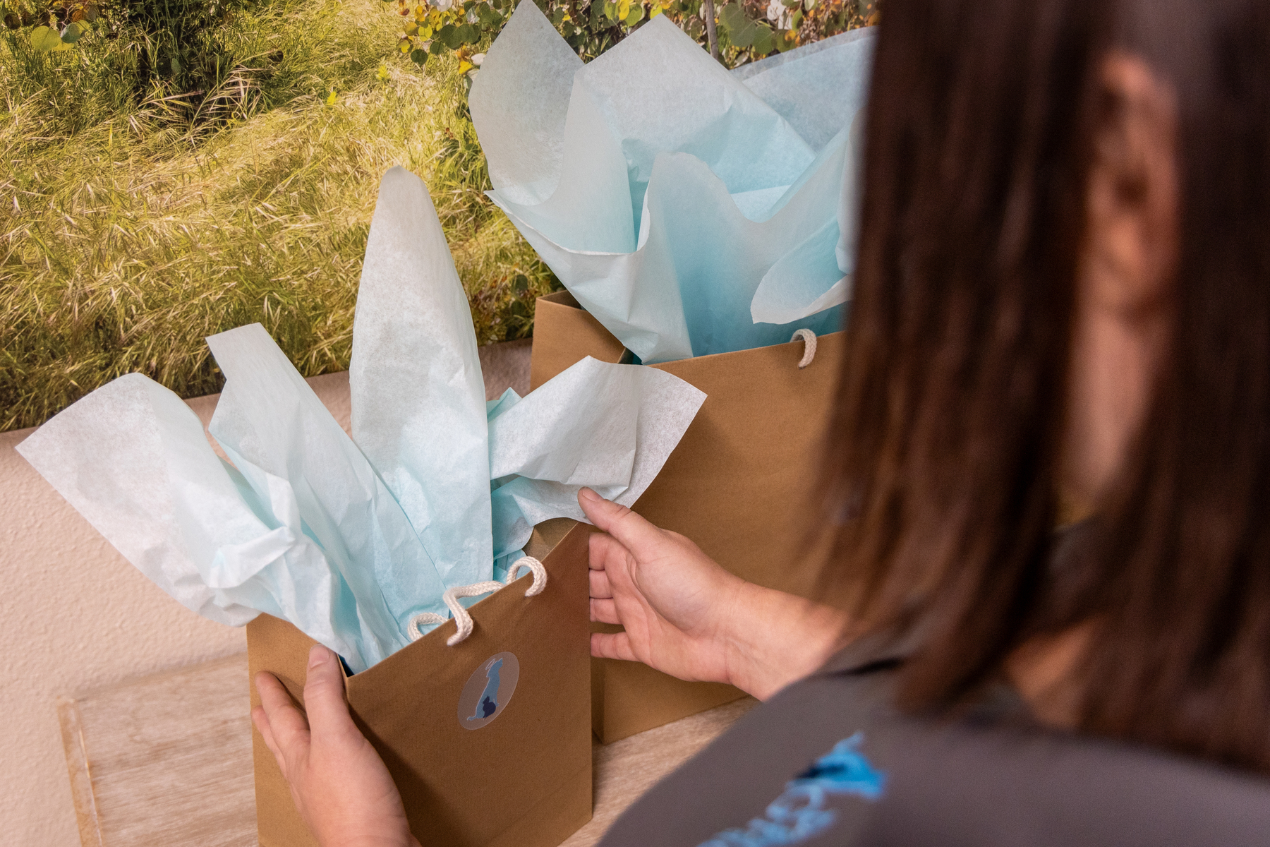 Woman arranging gift bags with tissue paper