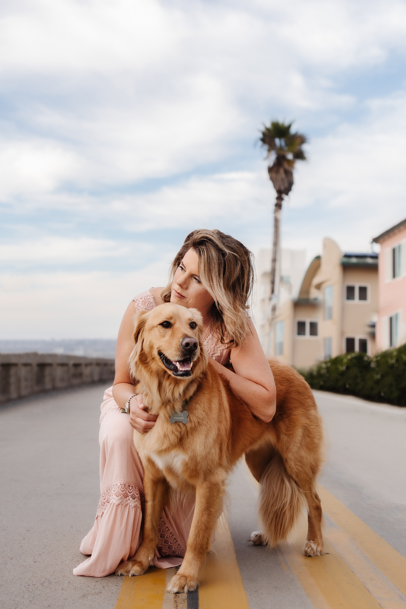 Woman posing with a golden retriever outdoors