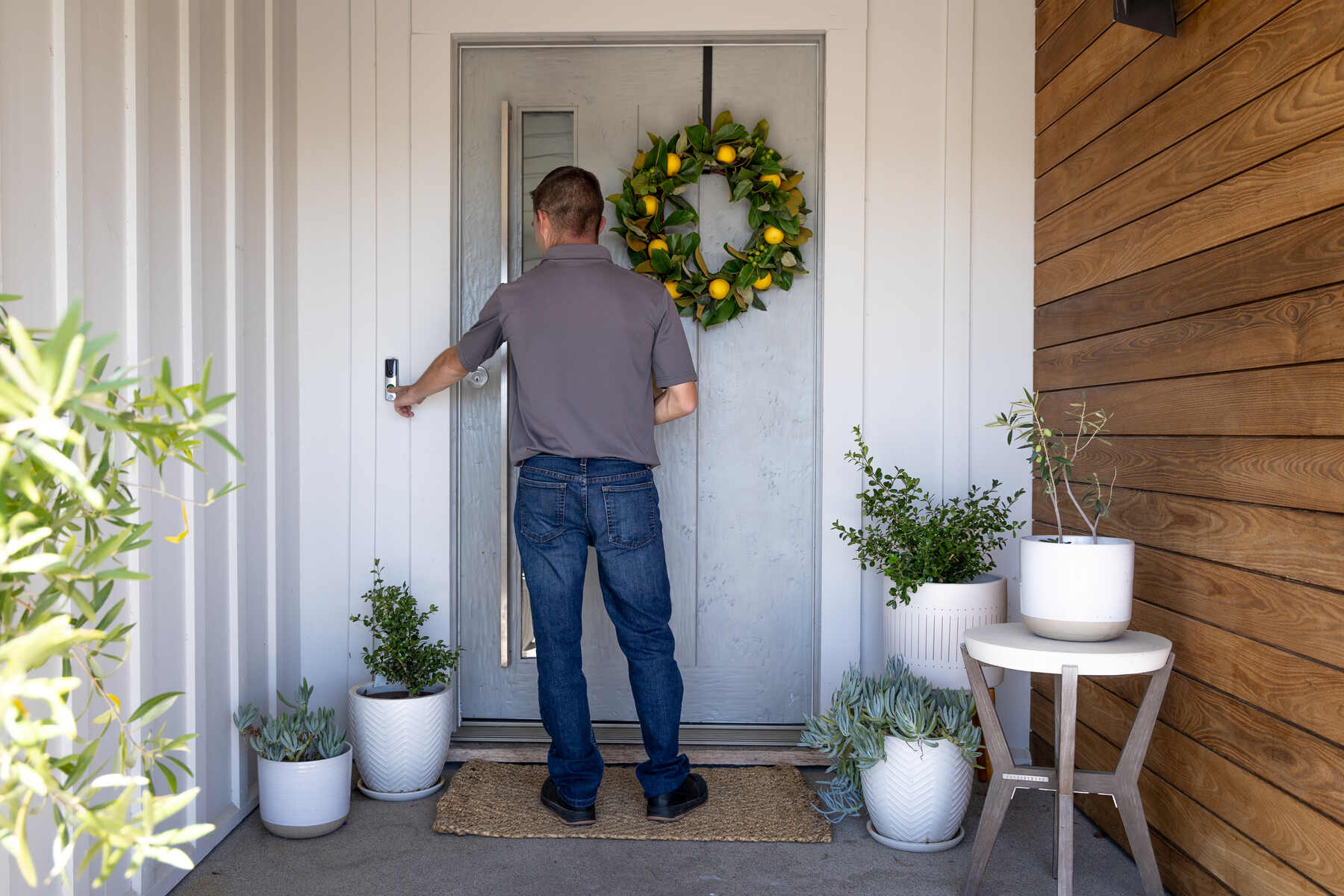 Man opening the front door of a home