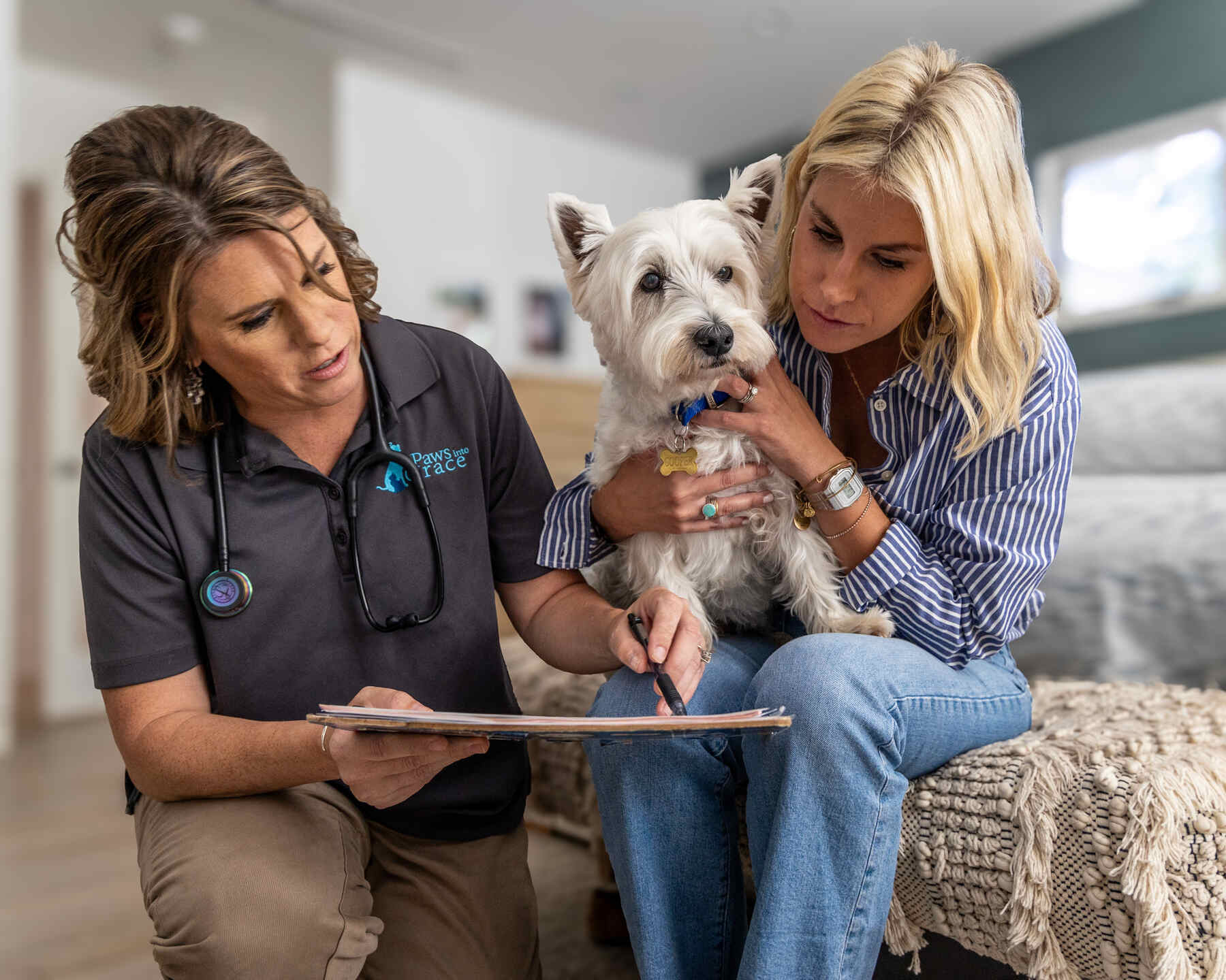 Veterinarian consulting with a woman holding her dog